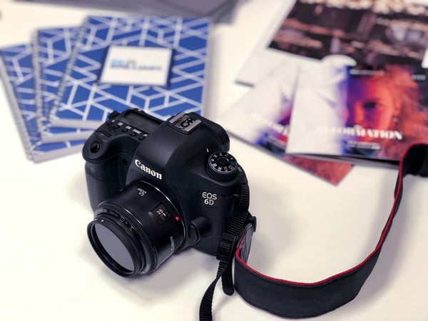 camera on table with brochures