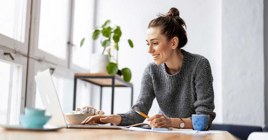 creative woman using laptop at desk