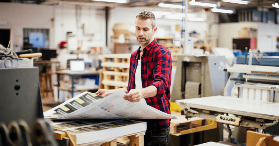 Adult man working in a printing press office